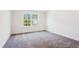 Bright bedroom with neutral carpet and a large picture window at 83 Artic Circle, Garner, NC 27529