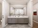 Bathroom featuring double sinks, marble countertops, gold fixtures and ceramic floors at 154 Colonial Trail Ct, Pittsboro, NC 27312