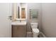Stylish powder room with a marble countertop vanity and heated towel rack at 154 Colonial Trail Ct, Pittsboro, NC 27312
