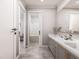Bathroom with double sinks, marble countertop, and an adjoining room with a bathtub at 154 Colonial Trail Ct, Pittsboro, NC 27312