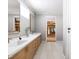Bathroom featuring a vanity with double sinks, quartz countertop, and a walk-in closet at 154 Colonial Trail Ct, Pittsboro, NC 27312