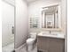 Modern bathroom featuring a glass-enclosed shower and a vanity with a marble countertop and sleek fixtures at 154 Colonial Trail Ct, Pittsboro, NC 27312