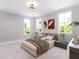Bright bedroom featuring neutral tones, two windows, overhead lighting and stylish decor at 154 Colonial Trail Ct, Pittsboro, NC 27312