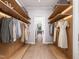 Spacious walk-in closet with custom shelving and hardwood floors and door leading to Kitchen at 154 Colonial Trail Ct, Pittsboro, NC 27312
