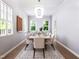 Sun-filled dining room with seating for eight, perfect for entertaining guests at 154 Colonial Trail Ct, Pittsboro, NC 27312