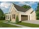 Side view of house with a two-car garage, well-maintained lawn, and coordinated exterior finishes at 154 Colonial Trail Ct, Pittsboro, NC 27312