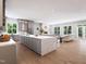 Bright, open-concept kitchen with white marble countertops, gray cabinets, and an adjoining living space at 154 Colonial Trail Ct, Pittsboro, NC 27312