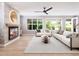 Cozy living room featuring a fireplace with stone surround and stylish furniture arrangement under a ceiling fan at 154 Colonial Trail Ct, Pittsboro, NC 27312