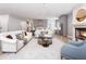 Bright and open living room showcasing a kitchen, fireplace, modern furniture, and hardwood floors at 154 Colonial Trail Ct, Pittsboro, NC 27312