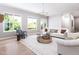 A spacious living room filled with natural light, featuring elegant furnishings and a light colored area rug at 154 Colonial Trail Ct, Pittsboro, NC 27312