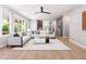 Spacious living room with modern furnishings, a large rug, and views through expansive windows and open concept at 154 Colonial Trail Ct, Pittsboro, NC 27312
