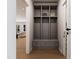 Mudroom with gray cubbies and drawers for storage, next to the laundry room and an opening to the kitchen at 154 Colonial Trail Ct, Pittsboro, NC 27312