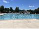 Outdoor community swimming pool with a slide and plenty of lounge chairs at 154 Colonial Trail Ct, Pittsboro, NC 27312