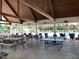 Covered outdoor poolside lounge area with picnic tables and ping pong at 154 Colonial Trail Ct, Pittsboro, NC 27312