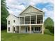 The rear of the home showcases a screened porch, patio, and a large lawn area at 154 Colonial Trail Ct, Pittsboro, NC 27312