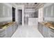 Bathroom featuring dual vanities with soft gray cabinets and a walk-in shower at 8305 Society Pl, Raleigh, NC 27615