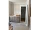 Bathroom with gray vanity featuring soft close drawers, countertops, and access to the walk-in closet at 8305 Society Pl, Raleigh, NC 27615