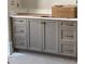 A modern bathroom vanity with gray cabinets, brass hardware and a white countertop at 8305 Society Pl, Raleigh, NC 27615