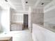 Bathroom featuring a vanity with gray cabinets and a walk-in shower with tiled walls at 8305 Society Pl, Raleigh, NC 27615