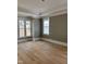 Spacious bedroom with elegant hardwood floors, neutral walls, and large windows at 8305 Society Pl, Raleigh, NC 27615