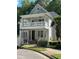 Two-story home featuring a covered porch, white railings, and support columns at 8305 Society Pl, Raleigh, NC 27615
