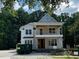 Two-story home featuring a covered porch with wooden railings and visible construction debris at 8305 Society Pl, Raleigh, NC 27615