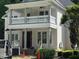 Two-story home featuring a covered porch, white railings, and support columns at 8305 Society Pl, Raleigh, NC 27615