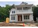 An in-progress exterior elevation of a home featuring a double porch with columns and detailed trim at 8305 Society Pl, Raleigh, NC 27615