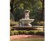 Outdoor water fountain surrounded by lush landscaping and mature trees in a park-like setting at 8305 Society Pl, Raleigh, NC 27615