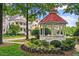 Community gazebo with red roof, white trim, green landscaping and a view of the neighborhood at 8305 Society Pl, Raleigh, NC 27615