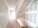 Bright hallway with hardwood floors and staircase at 8305 Society Pl, Raleigh, NC 27615