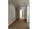 A bright hallway features crisp white trim, fresh paint, and newly installed hardwood floors at 8305 Society Pl, Raleigh, NC 27615