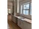 Bright kitchen with white cabinets, gold hardware, countertops and a window at 8305 Society Pl, Raleigh, NC 27615