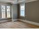 Sunlit living room featuring freshly painted walls, hardwood floors, and elegant trim at 8305 Society Pl, Raleigh, NC 27615