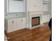 Living room features a stone fireplace, custom built-in cabinets, and hardwood floors at 8305 Society Pl, Raleigh, NC 27615