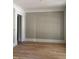 Living room with light hardwood floors and white trim at 8305 Society Pl, Raleigh, NC 27615