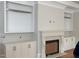 Living room with fireplace, built-in shelving and cabinets, and hardwood flooring at 8305 Society Pl, Raleigh, NC 27615