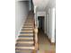 An in-progress staircase featuring wood steps with protective tape and a classic wooden banister at 8305 Society Pl, Raleigh, NC 27615