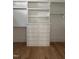 A bright, walk-in closet with custom built-ins featuring drawers and shelving at 8305 Society Pl, Raleigh, NC 27615