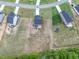 An aerial view of a property with a detached storage shed, situated in a desirable, modern residential neighborhood at 176 Van Winkle St, Lillington, NC 27546