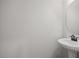 Simple half bathroom with pedestal sink and circular mirror at 176 Van Winkle St, Lillington, NC 27546