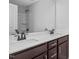 Modern bathroom with dual vanity, dark brown cabinets, and white countertops at 176 Van Winkle St, Lillington, NC 27546