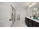 Modern bathroom with glass shower enclosure, dark vanity, and white porcelain toilet at 176 Van Winkle St, Lillington, NC 27546