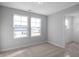 Spacious bedroom featuring two windows, carpet, and walk-in closet at 176 Van Winkle St, Lillington, NC 27546