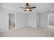 Secondary bedroom with ceiling fan, carpet flooring and access to bathroom at 176 Van Winkle St, Lillington, NC 27546