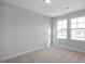 Bright bedroom with two large windows and plush carpeting at 176 Van Winkle St, Lillington, NC 27546