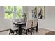 Modern dining room with large windows, contemporary decor, and stylish wood floors at 176 Van Winkle St, Lillington, NC 27546