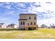 Two-story house with a deck, situated on a spacious grassy lot at 176 Van Winkle St, Lillington, NC 27546