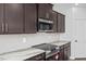 Stylish kitchen with granite countertops, hexagon tile backsplash and stainless steel appliances at 176 Van Winkle St, Lillington, NC 27546
