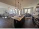Open kitchen with granite island, stainless steel appliances, and hardwood floors at 176 Van Winkle St, Lillington, NC 27546